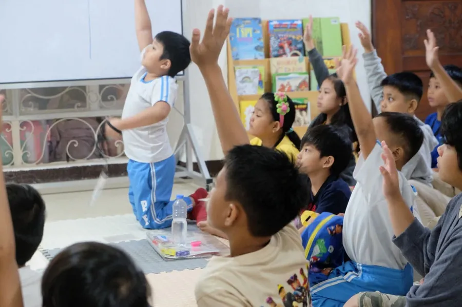 A boy reaching for books